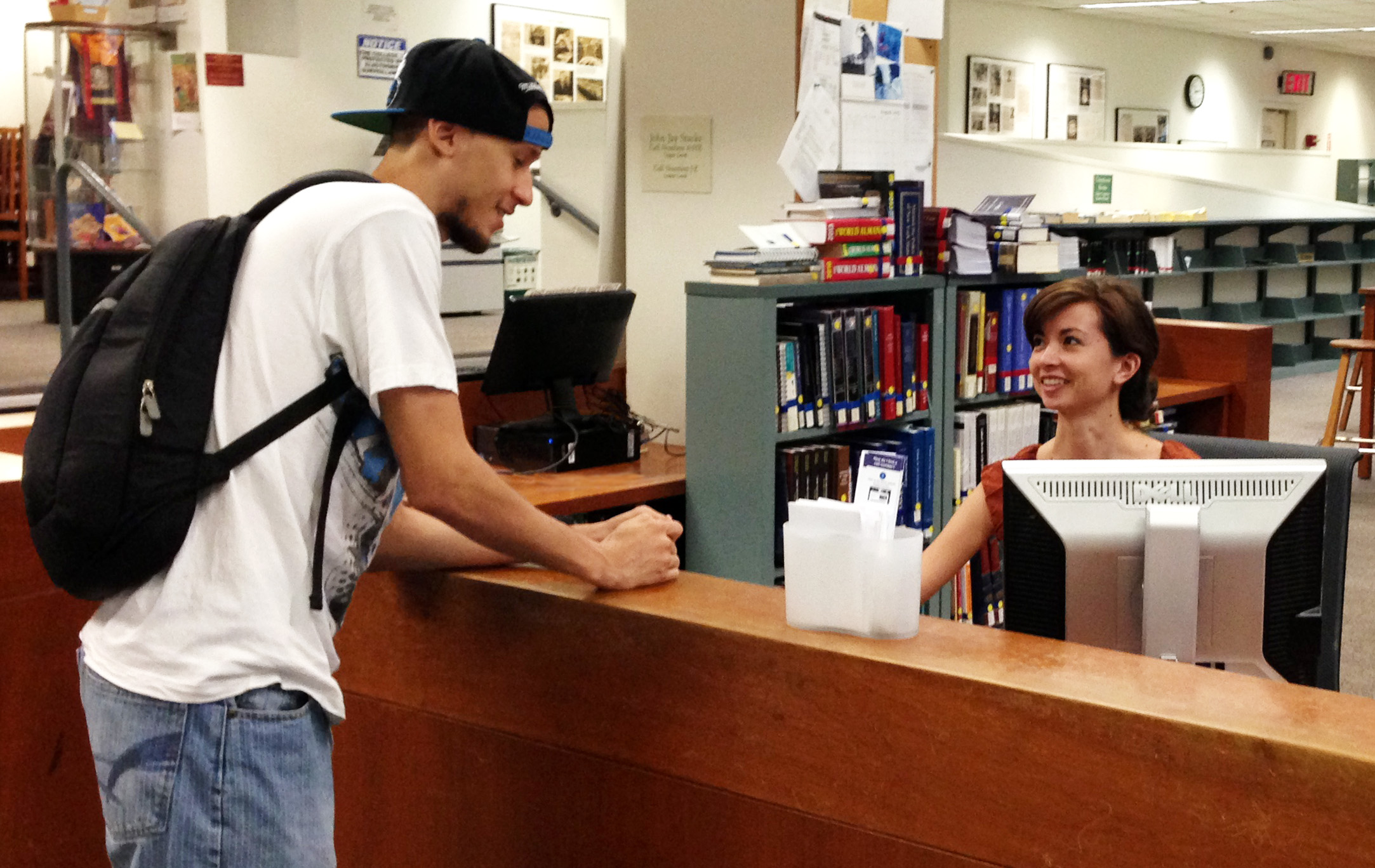 Librarian helping student
