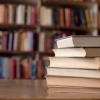 Books stacked on table in library