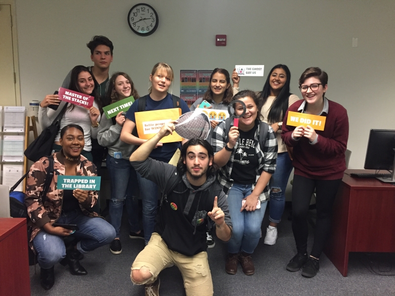 Students posing with signs